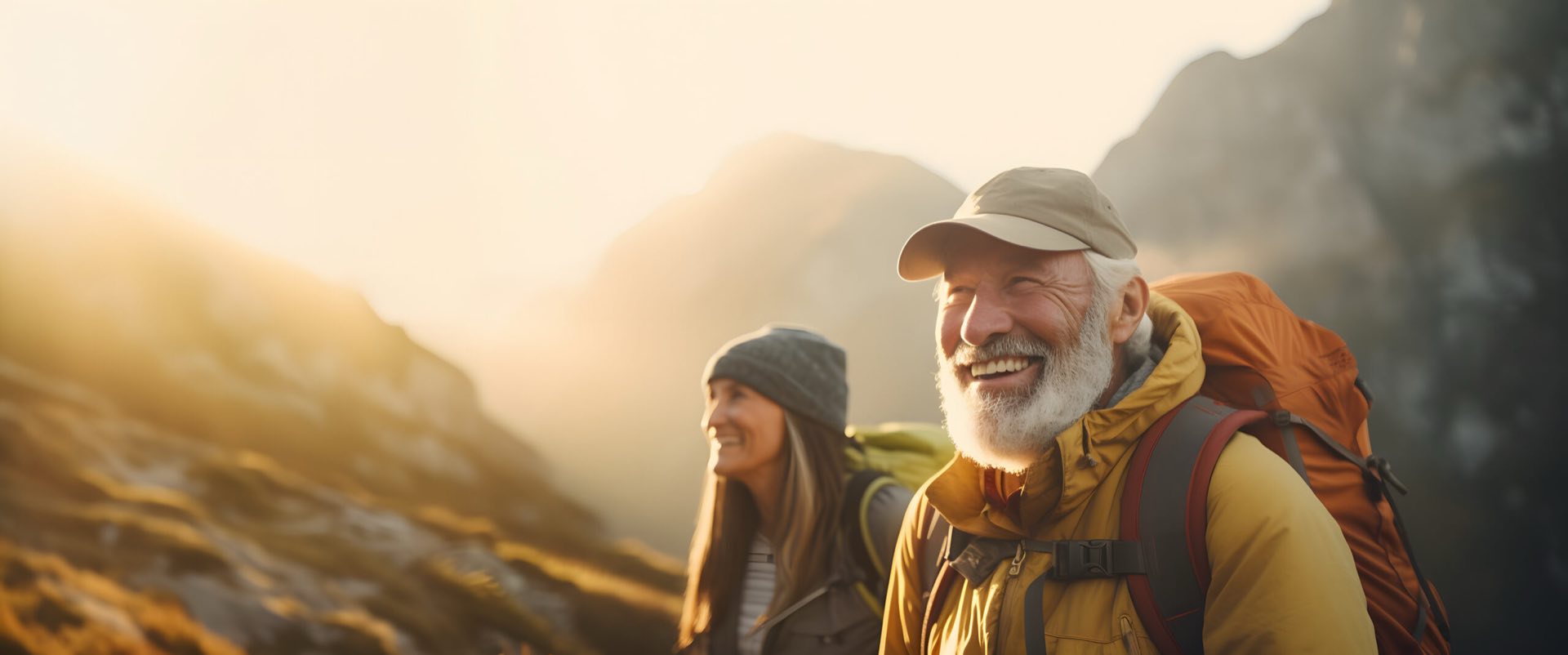 An older man and a younger woman hiking in the mountains