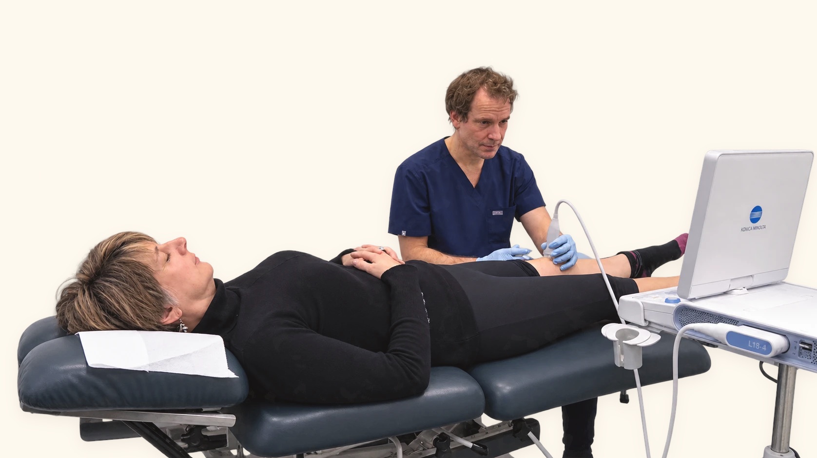 A clinician scanning a patient’s knee with ultrasound before a hyaluronic acid injection