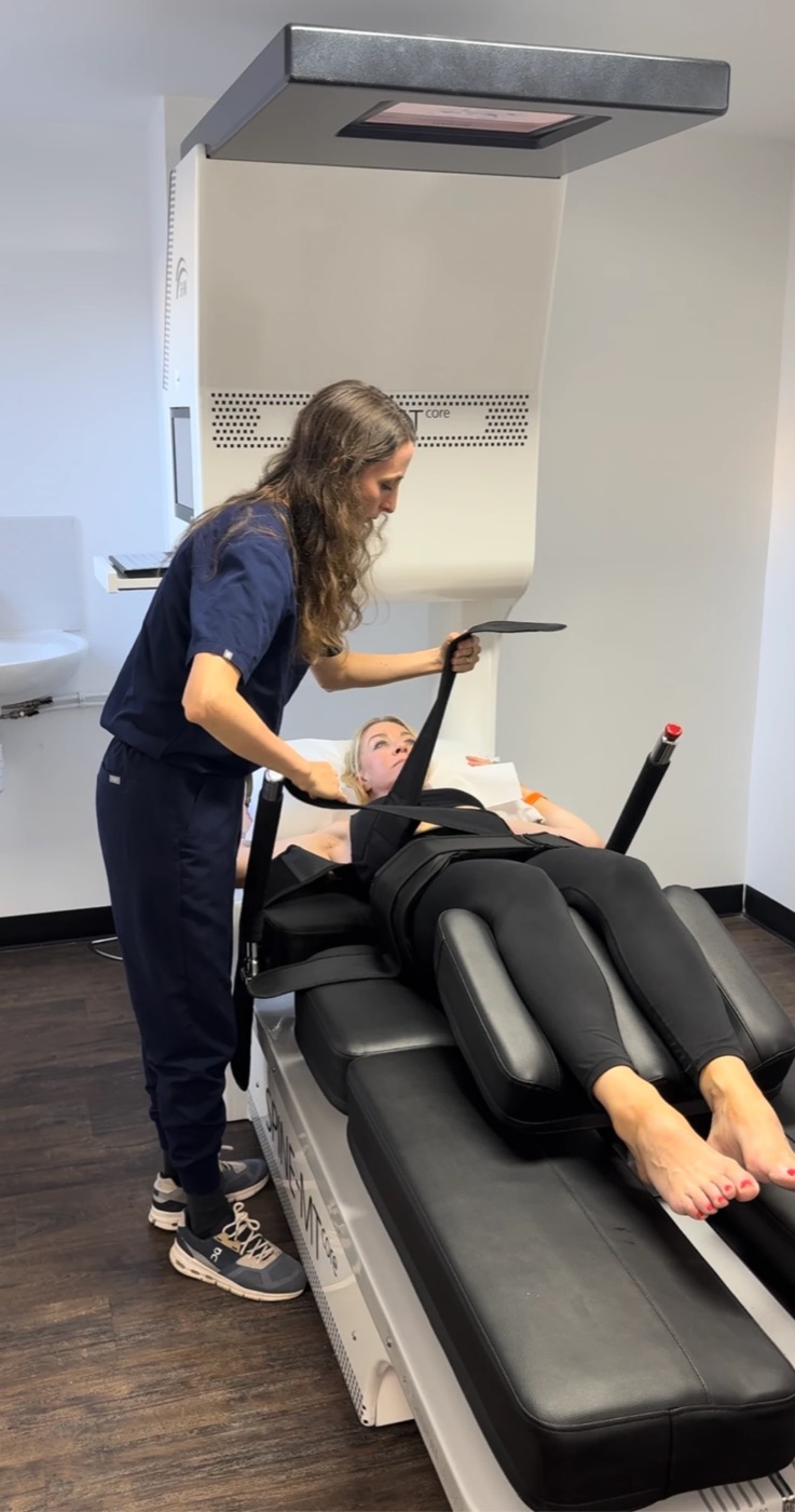 A clinician fitting the support belt before an MT Core session