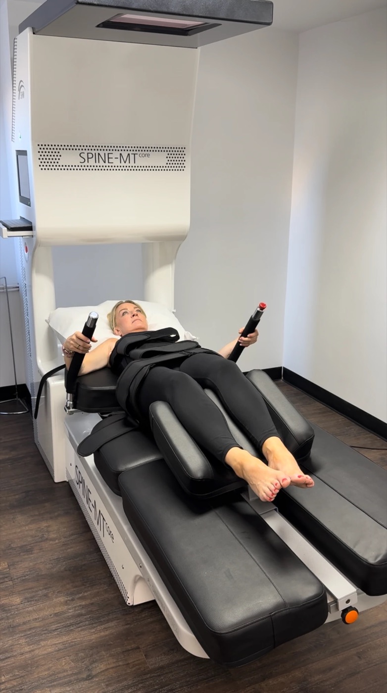 A patient lying comfortably on the Spine MT Core table during treatment
