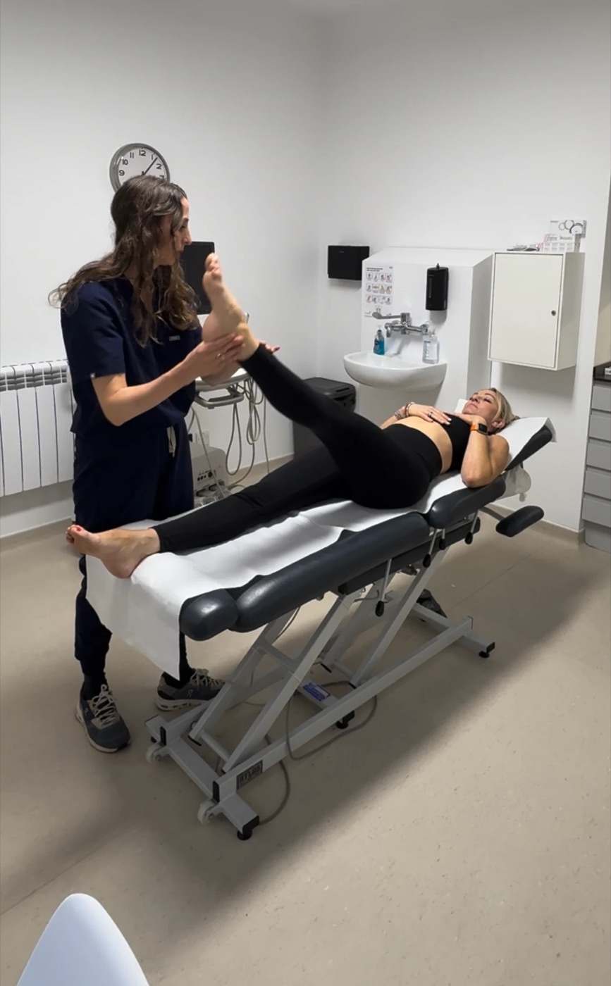 A chiropractor examining a patient’s leg